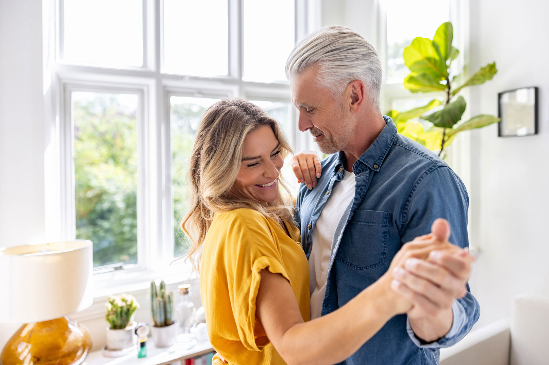 happy couple dancing in their kitchen
