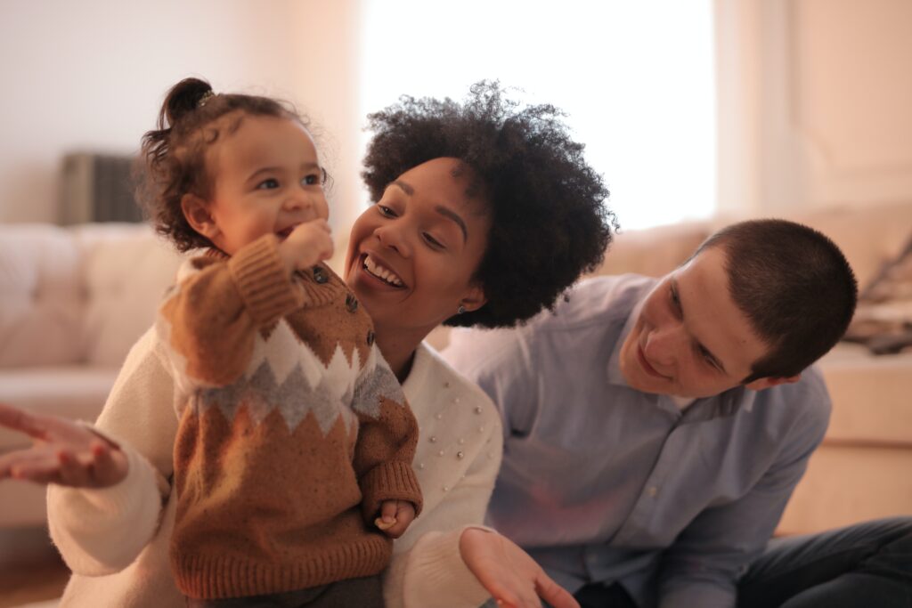 young family sitting together in living room