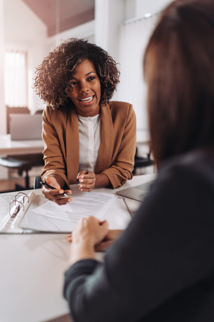 Young woman doing a job interview in the office and talking with client