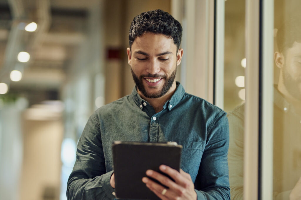 Confident Businessman Using Tablet indoors